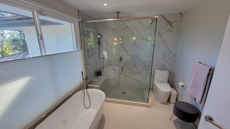 Remodeled master bathroom with freestanding tub and glass shower by Idea Fix Construction